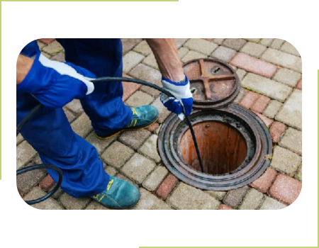 A person is using an air hose to connect the manhole cover.