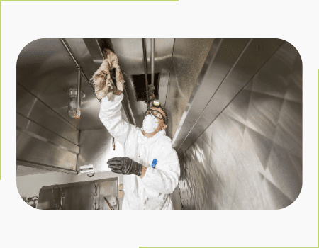 A man in white suit and black gloves working on an industrial area.