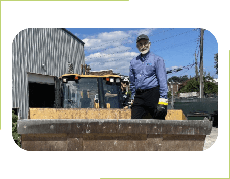 Atlantic Biofuels founder, Matt Topas, standing next to a construction vehicle.