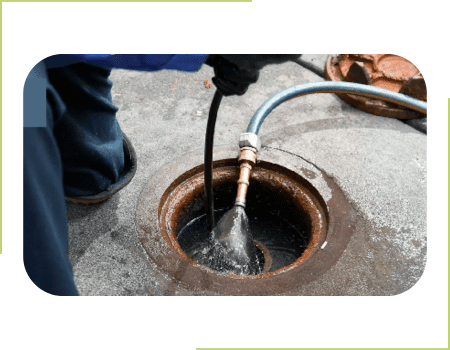 A person is using an air hose to connect the water pipe.